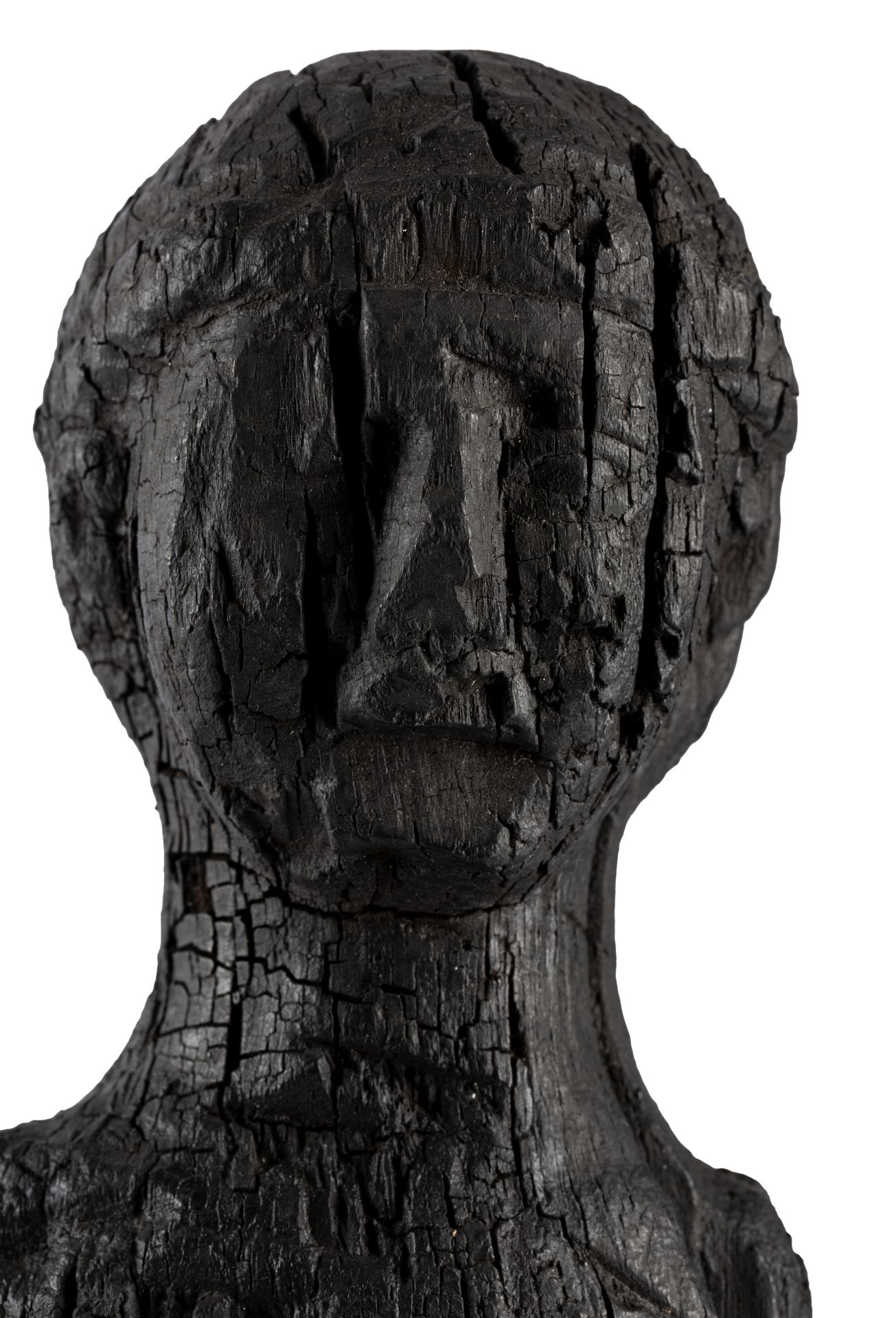 A charred wooden bust.